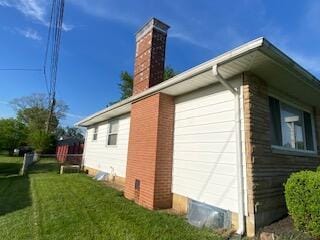 1616 Sale Rd, Columbus, OH 43224 - view of side of property featuring a chimney, a yard, and a garage