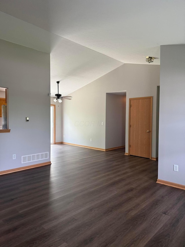 unfurnished living room with baseboards, vaulted ceiling, dark wood-style flooring, and a ceiling fan