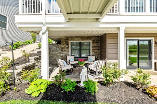 view of patio with a porch and a balcony