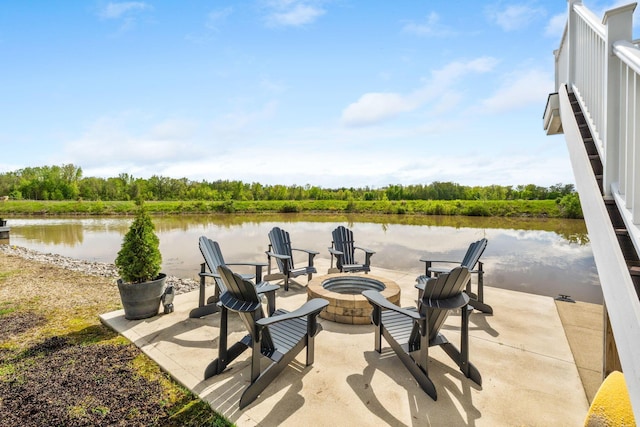 view of patio / terrace with a fire pit and a water view