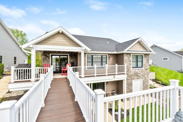 rear view of property with stone siding