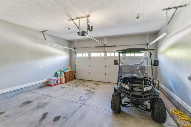 garage with a garage door opener and baseboards