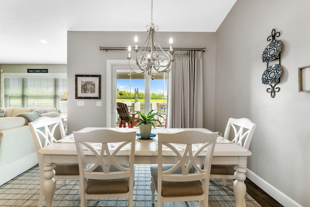 dining area with a chandelier, baseboards, wood finished floors, and recessed lighting