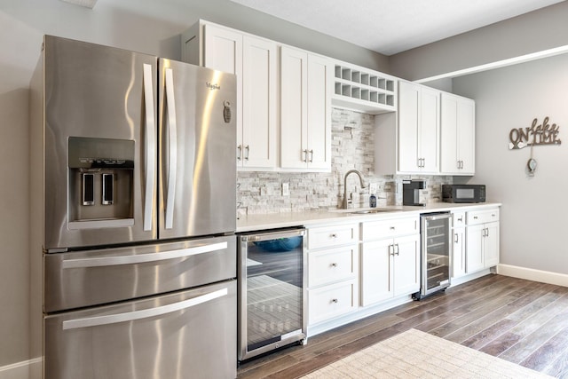 kitchen featuring stainless steel fridge with ice dispenser, wine cooler, a sink, and tasteful backsplash