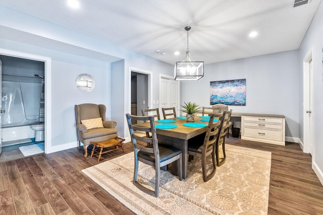 dining room featuring wood finished floors, recessed lighting, baseboards, and a chandelier