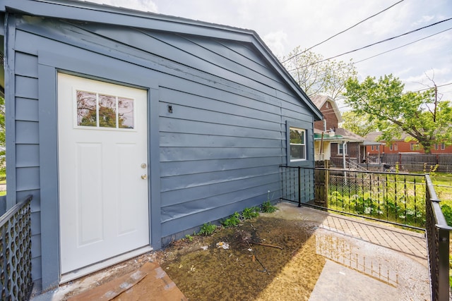 doorway to property featuring fence