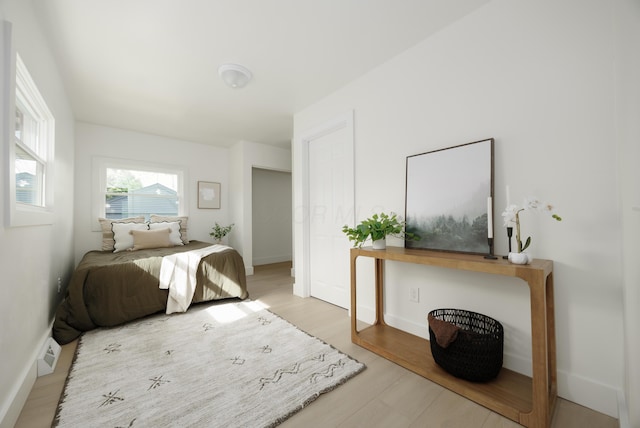 bedroom featuring wood finished floors and baseboards
