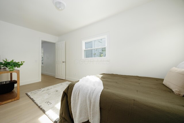 bedroom featuring light wood-style flooring and baseboards
