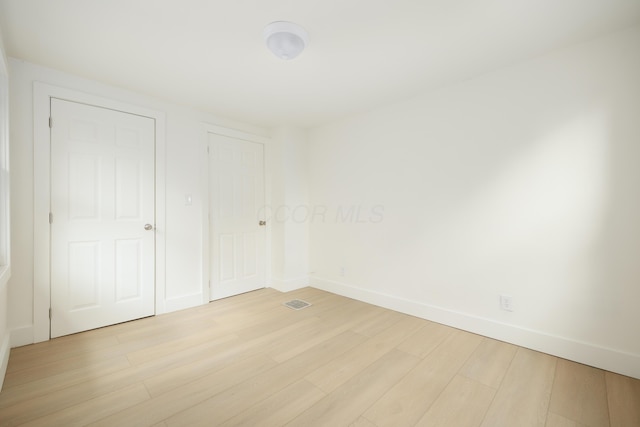 unfurnished room featuring light wood-style flooring and baseboards