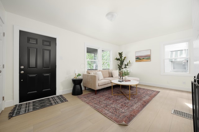living room with light wood finished floors and baseboards