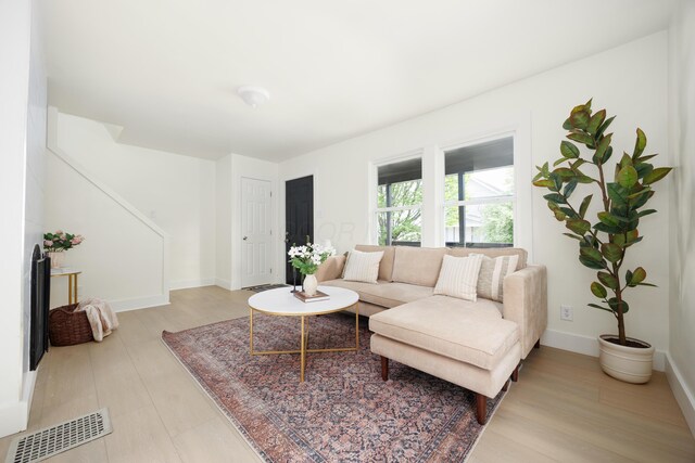 living area with light wood-style floors and baseboards