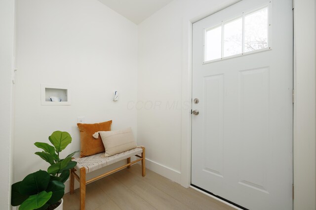 mudroom with light wood finished floors and baseboards