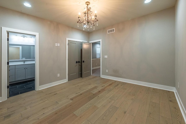 959 Hudson Xing, Columbus, OH 43212 - unfurnished bedroom featuring light wood-type flooring, baseboards, a closet, a chandelier, and recessed lighting