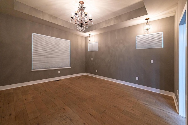 959 Hudson Xing, Columbus, OH 43212 - unfurnished room featuring a chandelier, hardwood / wood-style flooring, baseboards, and a tray ceiling