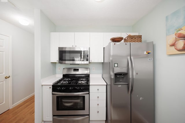 4618 Parrau Dr Unit 72B, Columbus, OH 43228 - kitchen featuring stainless steel appliances, white cabinets, light countertops, light wood-type flooring, and baseboards