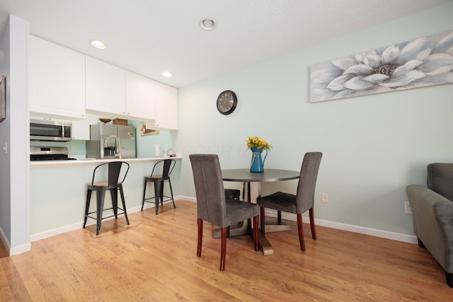 4618 Parrau Dr Unit 72B, Columbus, OH 43228 - dining space featuring light wood-type flooring, baseboards, and recessed lighting