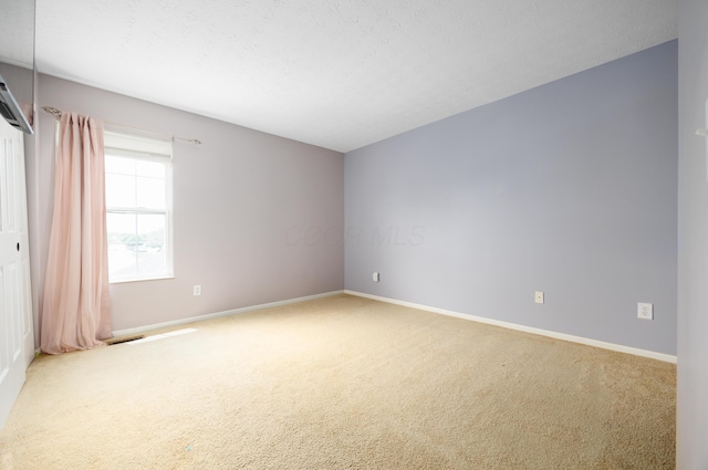 4618 Parrau Dr Unit 72B, Columbus, OH 43228 - carpeted empty room with baseboards and a textured ceiling