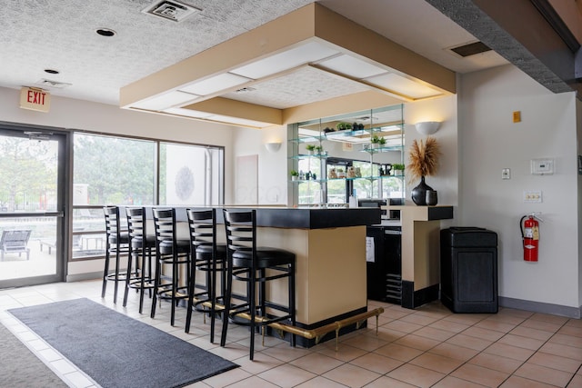 4618 Parrau Dr Unit 72B, Columbus, OH 43228 - indoor wet bar with light tile patterned flooring, a textured ceiling, and baseboards