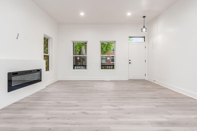 1177 Franklin Ave, Columbus, OH 43205 - unfurnished living room featuring heating unit, light wood-type flooring, recessed lighting, and baseboards
