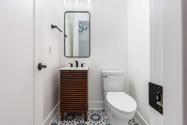 1177 Franklin Ave, Columbus, OH 43205 - half bathroom with baseboards, toilet, and vanity