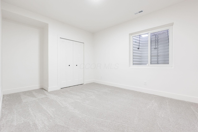 1177 Franklin Ave, Columbus, OH 43205 - unfurnished bedroom with light colored carpet, baseboards, and a closet