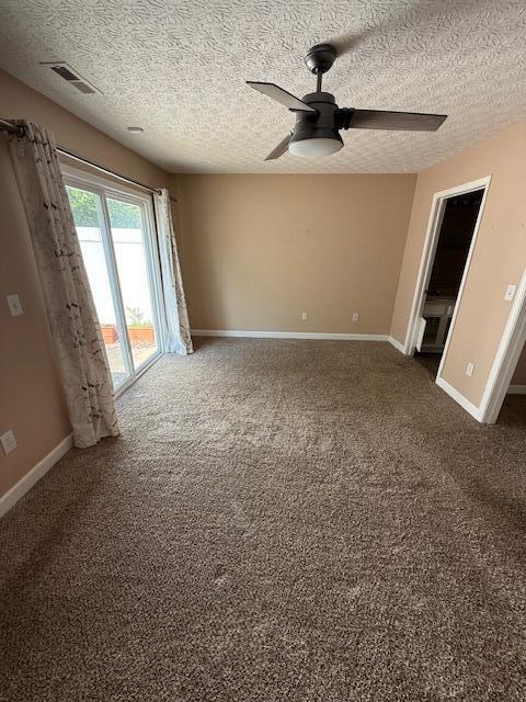 6983 Remsen Dr Unit 77A, Canal Winchester, OH 43110 - spare room featuring a textured ceiling, a ceiling fan, baseboards, and dark colored carpet