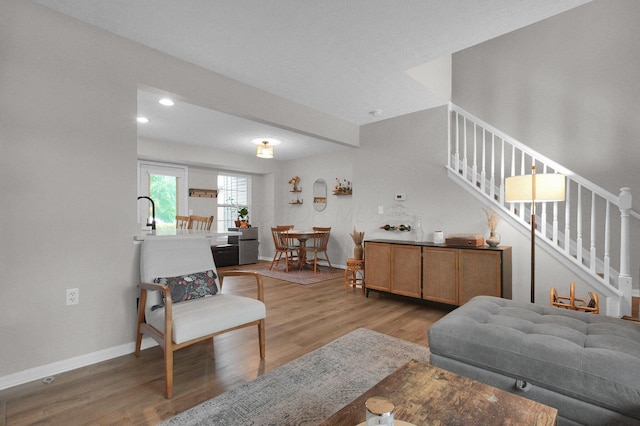 2999 Glenloch Cir, Dublin, OH 43017 - living area featuring stairs, wood finished floors, baseboards, and recessed lighting