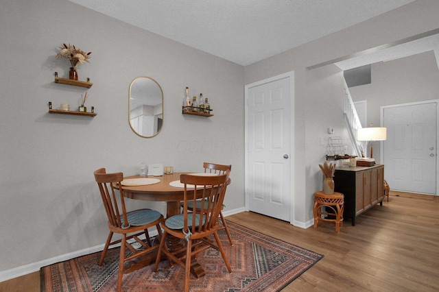 2999 Glenloch Cir, Dublin, OH 43017 - dining room with wood finished floors, baseboards, and a textured ceiling
