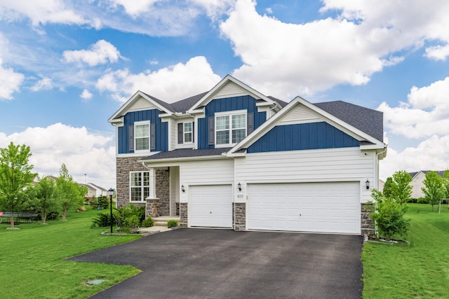 8123 Comstock Ter NW, Pickerington, OH 43147 - craftsman inspired home featuring board and batten siding, asphalt driveway, a front yard, and stone siding