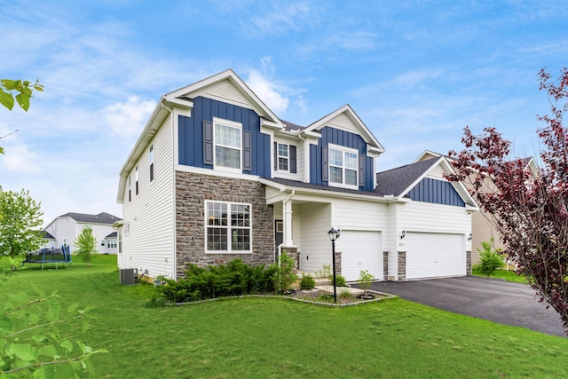 8123 Comstock Ter NW, Pickerington, OH 43147 - view of front of home featuring board and batten siding, a trampoline, and stone siding