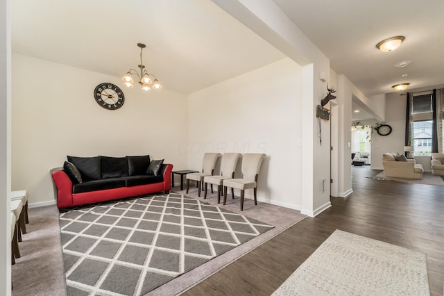8123 Comstock Ter NW, Pickerington, OH 43147 - living room with wood finished floors, a chandelier, and baseboards