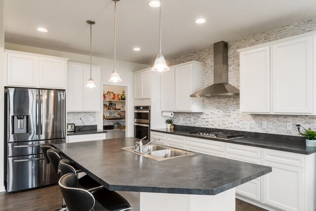 8123 Comstock Ter NW, Pickerington, OH 43147 - kitchen with appliances with stainless steel finishes, wall chimney exhaust hood, a sink, dark countertops, and backsplash