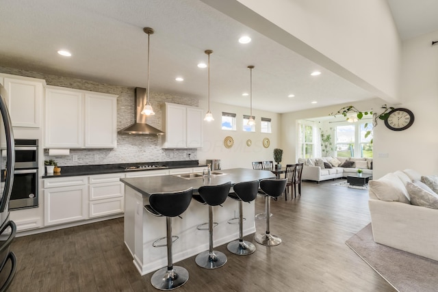 8123 Comstock Ter NW, Pickerington, OH 43147 - kitchen with wall chimney exhaust hood, open floor plan, gas stovetop, plenty of natural light, and recessed lighting