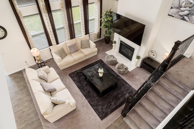 8123 Comstock Ter NW, Pickerington, OH 43147 - living area featuring healthy amount of natural light, a fireplace with flush hearth, and baseboards