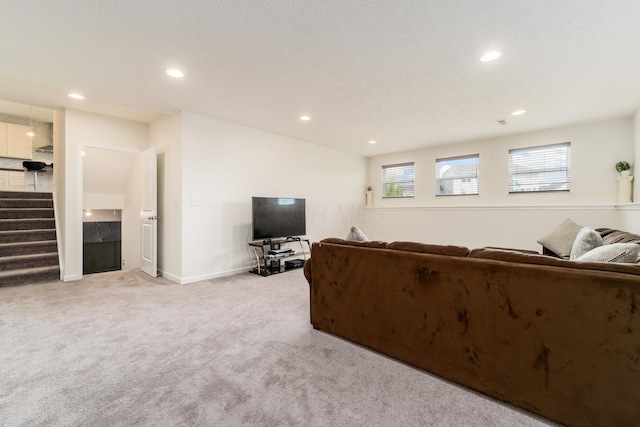 8123 Comstock Ter NW, Pickerington, OH 43147 - living area with stairs, light colored carpet, recessed lighting, and baseboards