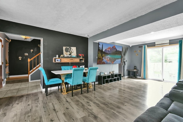 3072 Bocastle Ct, Reynoldsburg, OH 43068 - dining area featuring a textured ceiling, wood finished floors, stairway, and baseboards