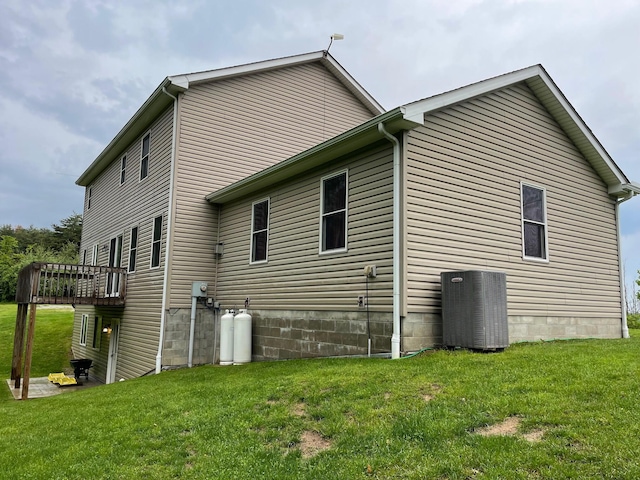 7719 Bear Run Rd, Logan, OH 43138 - view of side of property featuring central AC unit, a lawn, and a wooden deck