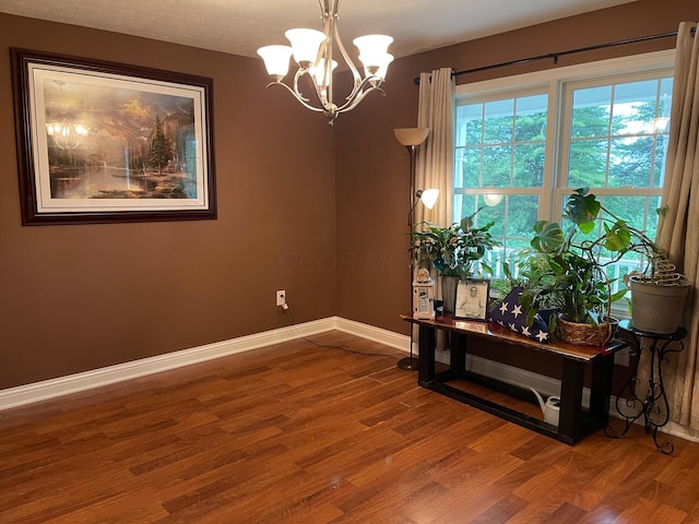 7719 Bear Run Rd, Logan, OH 43138 - spare room with wood finished floors, a chandelier, and baseboards