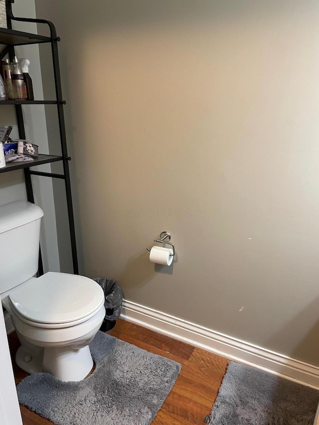 7719 Bear Run Rd, Logan, OH 43138 - bathroom featuring wood finished floors, toilet, and baseboards
