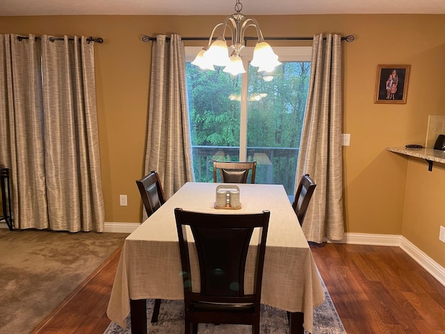 7719 Bear Run Rd, Logan, OH 43138 - dining area with a chandelier, dark wood-style floors, and baseboards