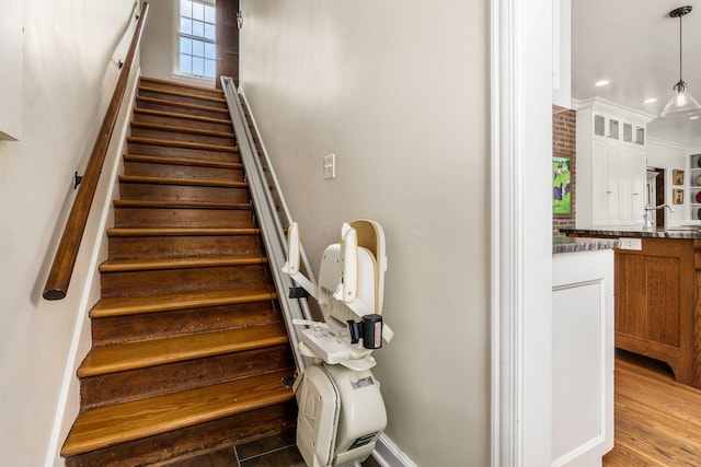 stairs featuring baseboards and wood finished floors