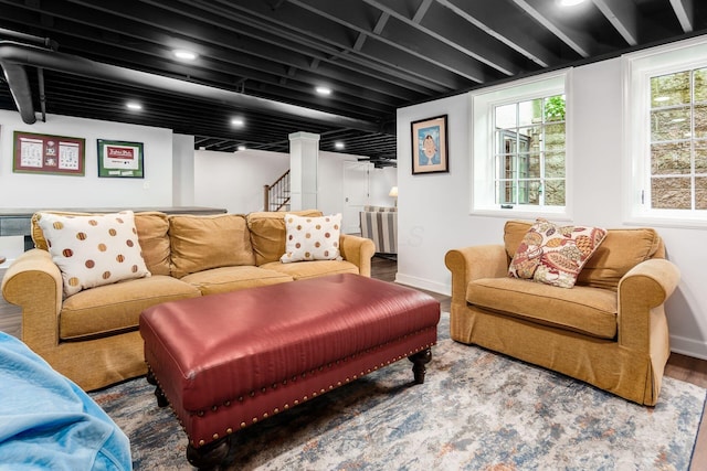 living room featuring wood finished floors, baseboards, stairway, and recessed lighting