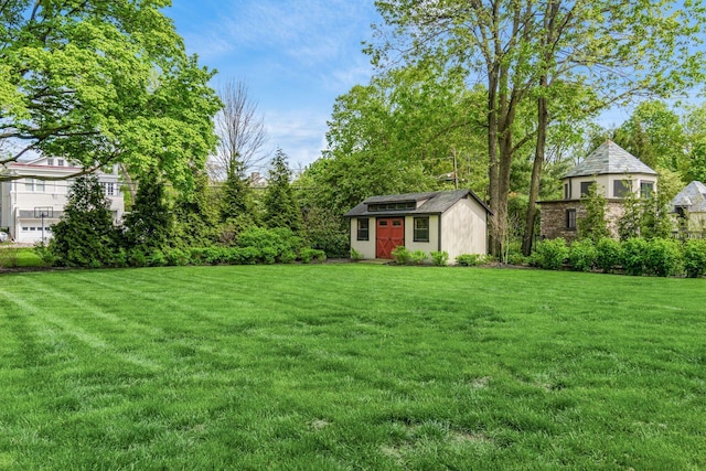 view of green lawn with an outdoor structure and a storage shed