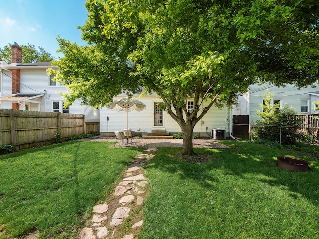 view of yard with entry steps and central AC