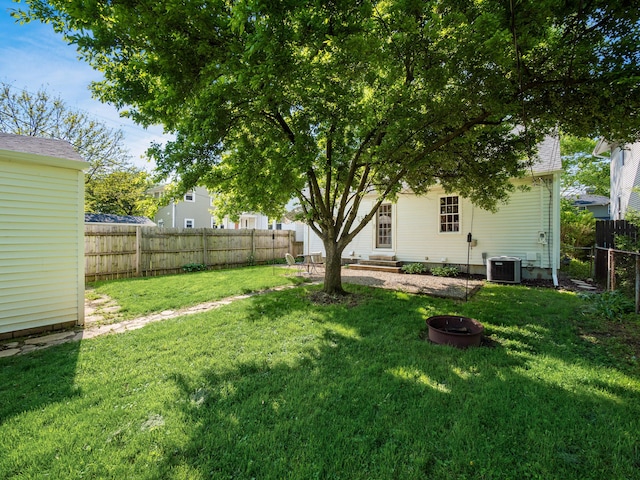 view of yard featuring entry steps and a fire pit