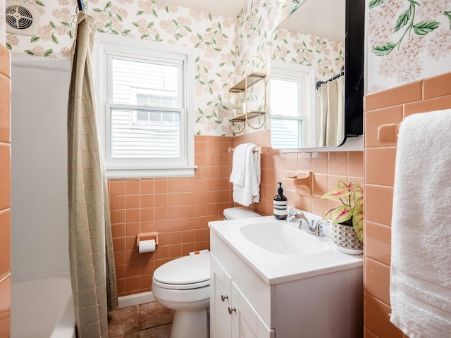 full bath featuring wallpapered walls, toilet, vanity, tile walls, and tile patterned floors