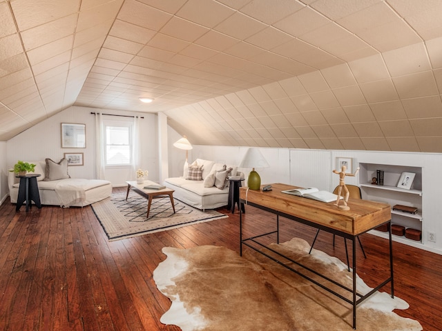 office space featuring hardwood / wood-style floors, vaulted ceiling, and baseboards