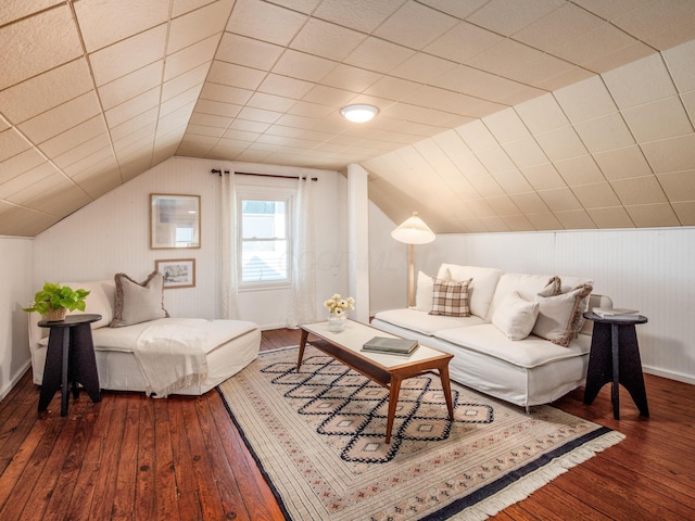 living room with wood-type flooring, lofted ceiling, and wood walls