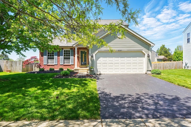 8380 Squad Dr, Galloway, OH 43119 - view of front of home featuring driveway, brick siding, and an attached garage