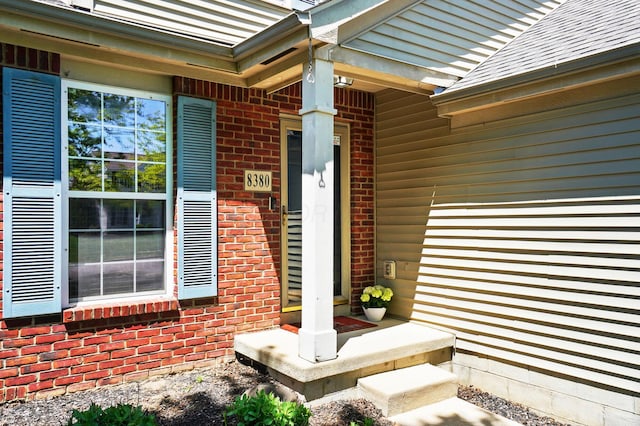 8380 Squad Dr, Galloway, OH 43119 - property entrance featuring brick siding and a shingled roof